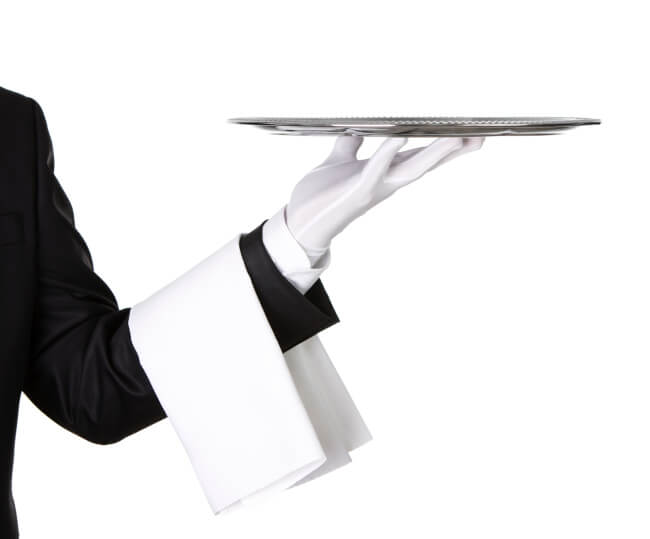 Butler with a white glove holding a silver platter.