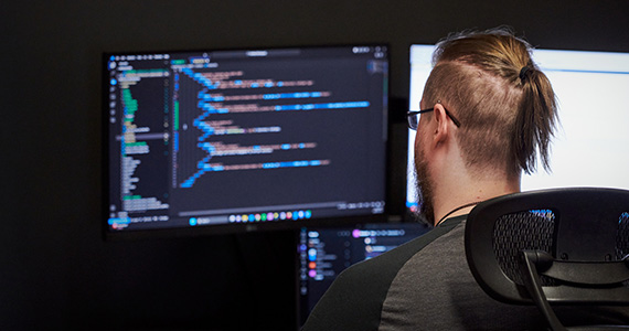 Developer coding on a screen